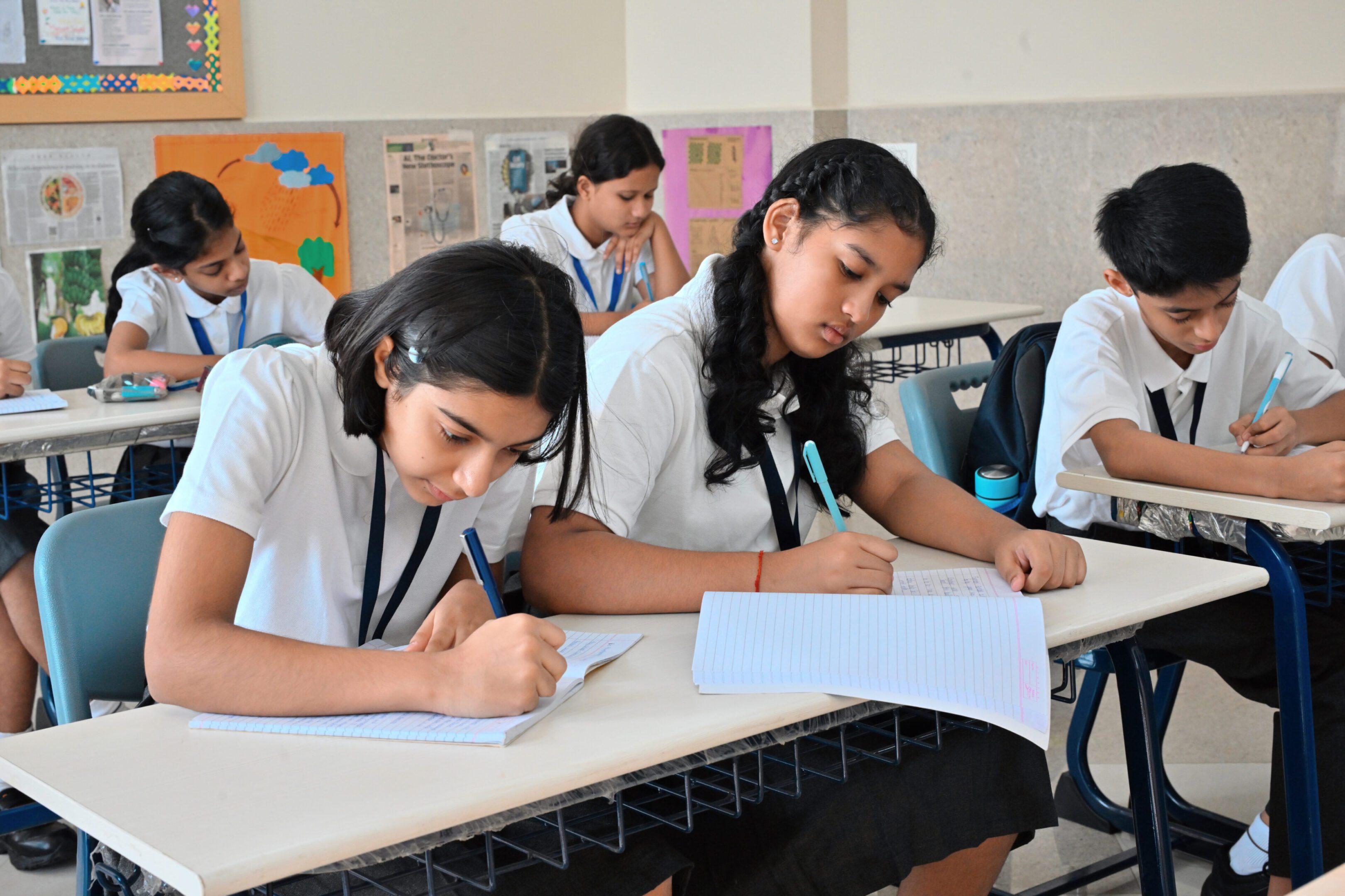 Students focused on writing in classroom.